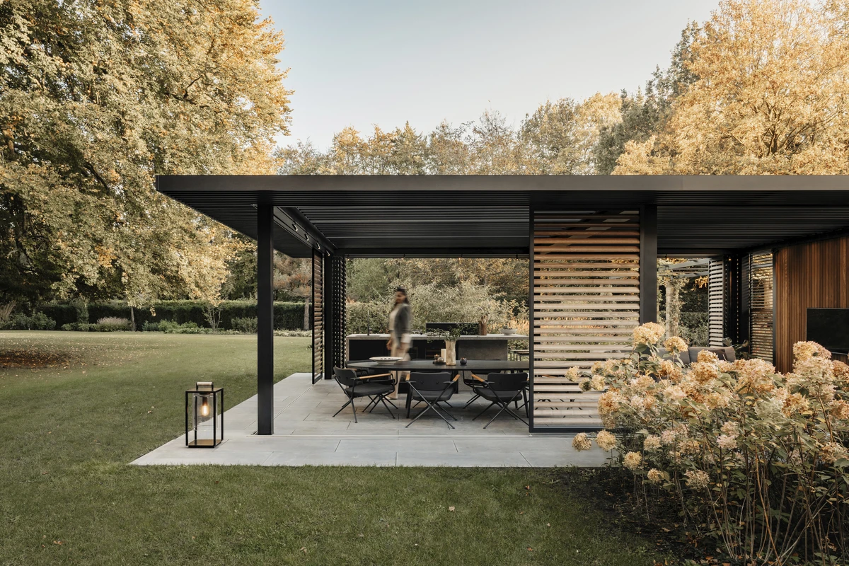 Pérgola Amani de Renson con techo de lamas orientables, marquesina de lamas, pares fijas y paneles Loggia, diseño moderno y confort total al aire libre.